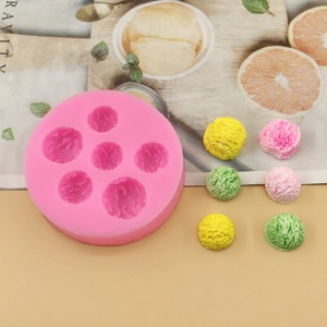 Detail of 6-cavity pink silicone ice cream mold with colorful sample finished desserts