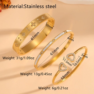 Three 18k gold plated stainless steel bangles with clover and heart patterns