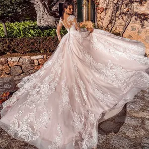 Luxury long sleeve lace wedding dress with a grand train and sheer button-back design