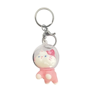 Pink and white space cat astronaut keychain with transparent helmet on white background