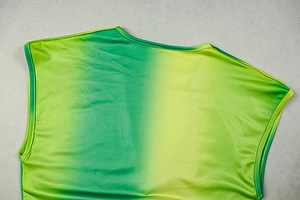 Detail view of the green gradient sleeveless dress showing knit texture and vibrant colors