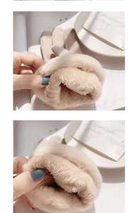 Detail view of beige suede gloves with thick plush faux fur lining for winter warmth
