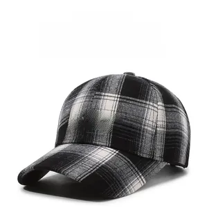 Close-up of black and white plaid baseball cap featuring BAHCK letter embroidery
