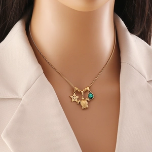 Gold stainless steel necklace featuring turtle, star, and green teardrop stone charms