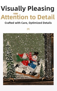 Detail of vintage metal frame music box with skiing snowmen and silver glitter inside