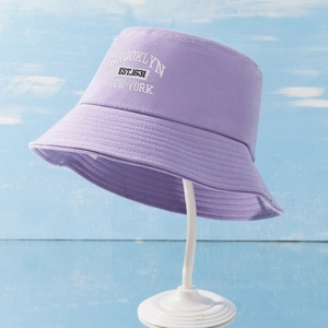 Detailed close-up of Brooklyn New York embroidery on light purple cotton bucket hat