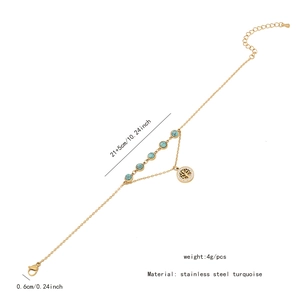 Detail of double-layer gold stainless steel anklet with turquoise flower and heart
