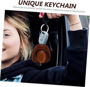 Close-up of brown suede mini cowboy hat keychain with silver star and metal ring