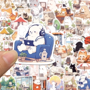 Close-up of cute cartoon animal stickers in hand showing detailed hand-drawn illustrations
