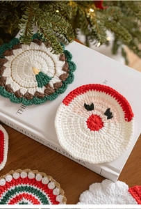 Detailed close-up of handmade crochet Christmas coasters with Santa and tree patterns