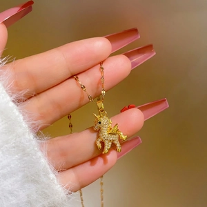 Golden unicorn pendant necklace with white zircons on a delicate chain for women