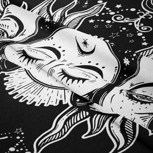 Detail shot of black and white moon and sun tapestry showing polyester fabric texture