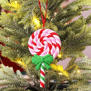 Christmas lollipop ornament with red white spirals and green bow on tree