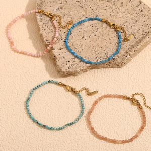Detail of 18K gold plated beaded anklets with colorful natural stones and lobster clasp