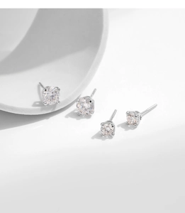 Macro detail of S925 sterling silver stud earrings with four-prong round moissanite