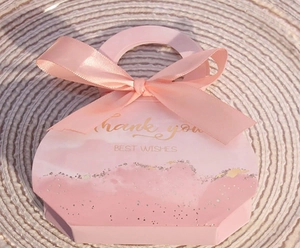 Detailed view of pink gift box with Thank You gold foil text and soft ribbon bow