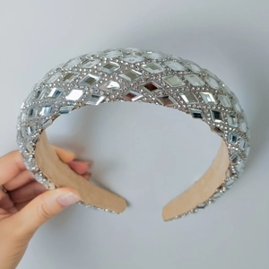 Detail of silver rhinestone wide headband with mirror finish and sponge padding