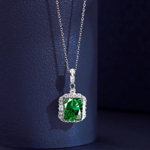 Detail of S925 silver necklace with rectangular emerald green zircon and micro pavé crystals