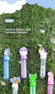 Close-up of colorful cartoon bubble wands on grass with mermaid and unicorn tops