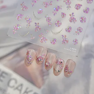 Detail view of shimmering shell-effect nail stickers with pink rose and pearl designs
