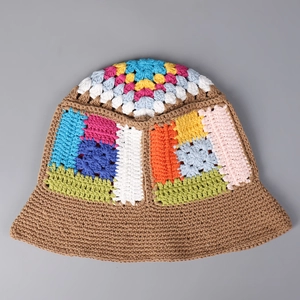Detail of colorful granny square crochet bucket hat with intricate handmade knit patterns