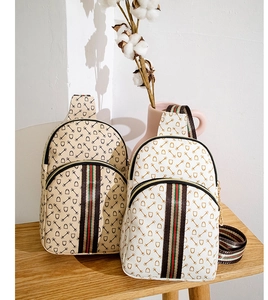 Detail of vintage equestrian print chest bags with signature striped webbing trim