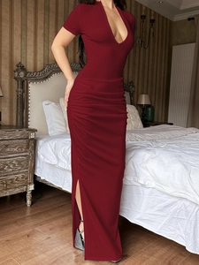 Deep red bodycon maxi dress with deep V-neck, side ruching, and elegant slit detail