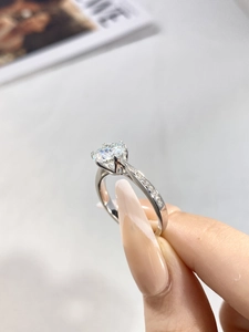 Detailed view of 6-prong moissanite engagement ring in sterling silver on hand