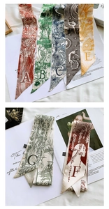 Close-up of French vintage silk twilly scarves with elegant letter prints and patterns