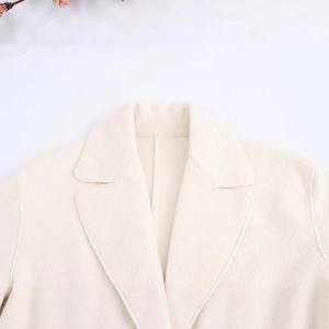 Women's cream white wool blend long coat featuring a stylish notched lapel collar