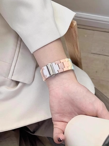 Detail of colorful resin watch band with three-link structure and silver butterfly clasp