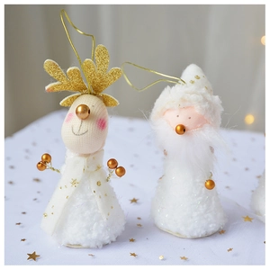 Detail of plush reindeer and Santa hanging ornaments in white and gold with bells