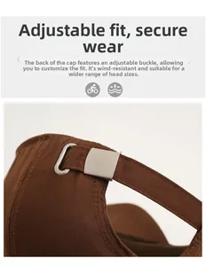 Detail of brown cotton baseball cap featuring an adjustable metal slider buckle and stitching