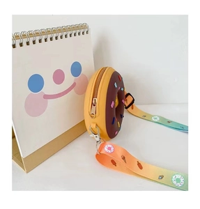 Detail of donut-shaped silicone mini bag with rainbow strap and chocolate frosting