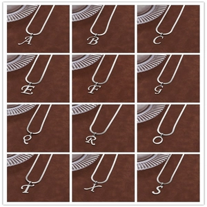 Detailed grid view showing various silver letter pendants on classic snake chains