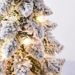 Mini Nordic flocked Christmas tree with warm white LED lights for festive holiday tabletop decor