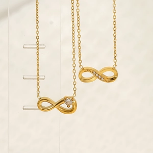 Elegant gold titanium steel infinity necklace with sparkling zircon heart on display stand