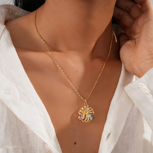 Detail of 18K gold plated necklace with hollow flower pendant and colorful zircon stones
