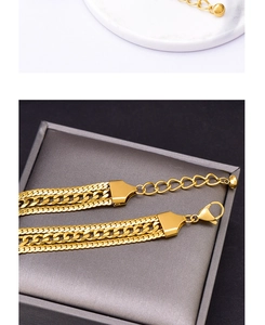 Detail of gold double-layer snake and box chain with adjustable lobster clasp closure