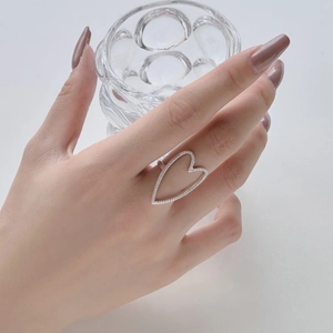 Elegant S925 sterling silver hollow heart ring with sparkling pave cubic zirconia on model