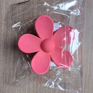 Matte pink flower hair claw clip for women made of durable resin in packaging
