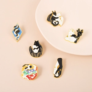 Macro detail of six enamel animal lapel pins on minimalist display plates