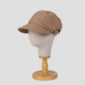 Khaki cotton newsboy cap with wide brim and decorative metal button on a display head