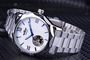 Detail view of WINNER automatic mechanical watch with skeleton dial and blue hands