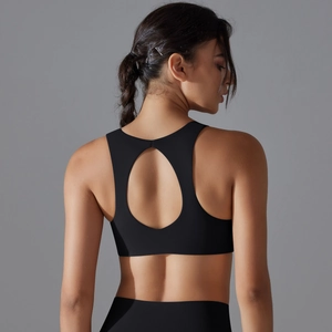 Detail of black sports bra featuring a racerback with central oval cutout and elastic fabric