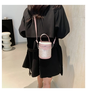 Chic pink and cream bucket bag shown on model to demonstrate size and styling
