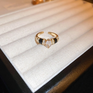 Macro shot of gold plated dragon ring with black enamel details and zircon stones