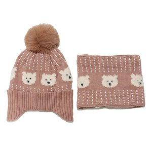 Detail of rose pink knitted hat and neck warmer set with cute bear jacquard patterns
