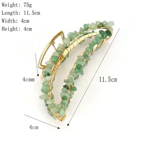 Handmade gold wire-wrapped banana hair claw clip with green natural crystal stones
