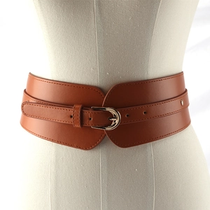 Classic brown elastic corset belt with metallic buckle on a white mannequin